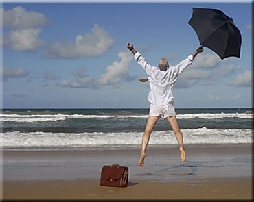 Business man jumping on beach